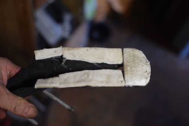 add some recycled felt to the back, to protect bike's paint job.  rubber would probably be better though.