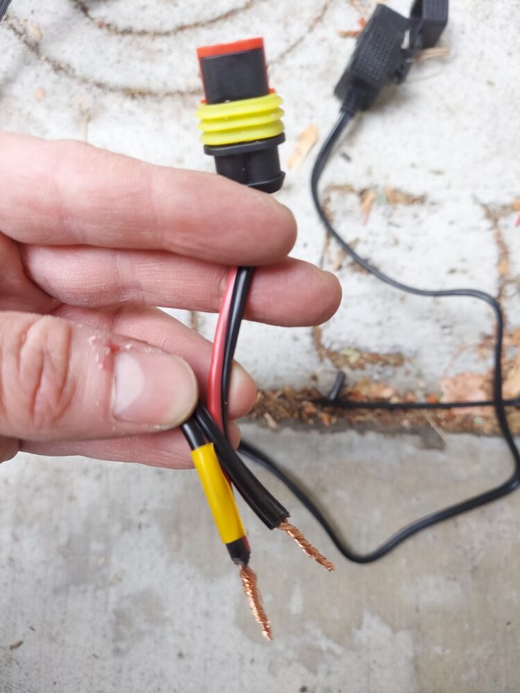 Splicing the wiring harness plug into the USB plug. I got the polarity wrong on the first attempt but it works fine once my error was corrected.