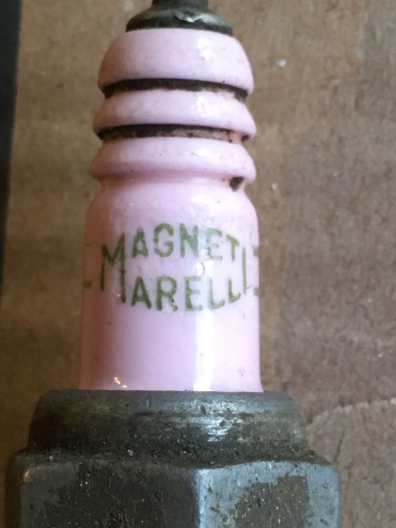 pink ceramic with Magneti Marelli brand plug