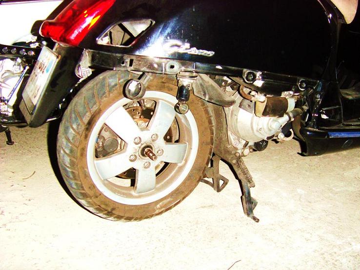Just pull the metal plate.
Sometimes, ball bearing is griped on drive shaft. In this way, you'll have to remove it with an hammer.
At reassembly, don't forget to lub it with a good grease (Teflon, graphite...)