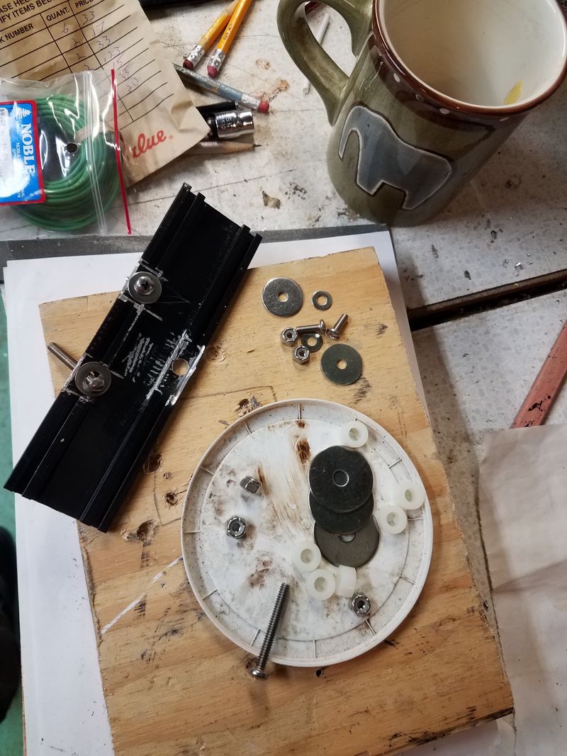 Nuts and bolts, and the piece of threshold that'll be used to attach the mounting chase and license plate. The original rubber seal for the 3 holes is still installed.