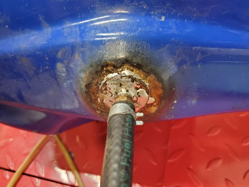 Bottom of the tank is welded with this plug to accept a fuel line, which attaches to that funky fuel tap.