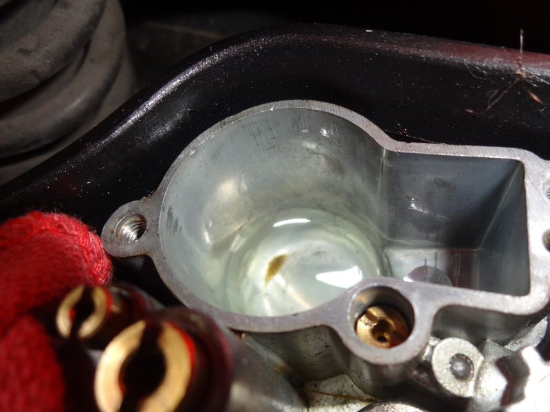 Crud in bottom of float bowl.