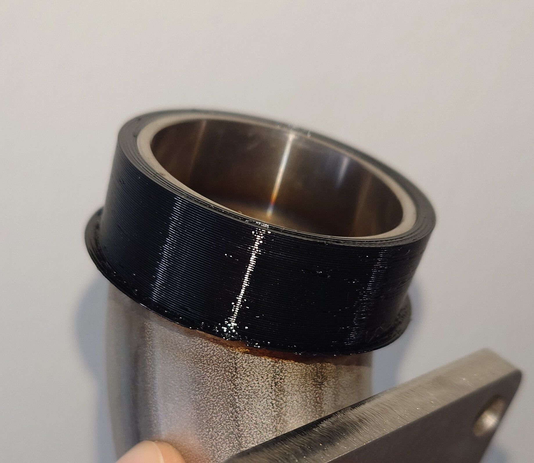 Has a lip which was actually a bed adhesion enforcer, but turned out to be a great stopper.