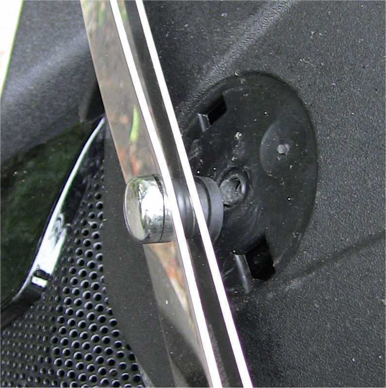 FIG 5: Center screw. A new hole has been drilled in the fairing just below the original hole normally hidden under the Piaggio nose badge. Note the rubber grommets between and behind the horizontal straps.
