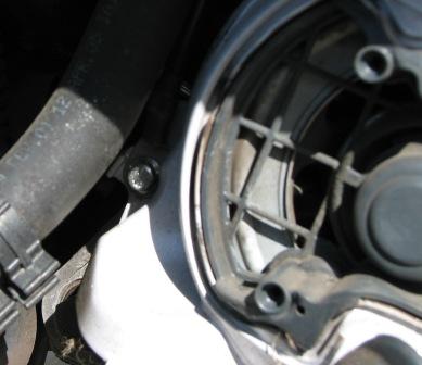 The front screw has a ground wire attached.