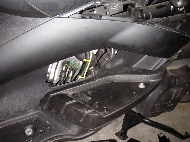 Wire from the battery run through appropriate spaces between the paneling and engine compartment.