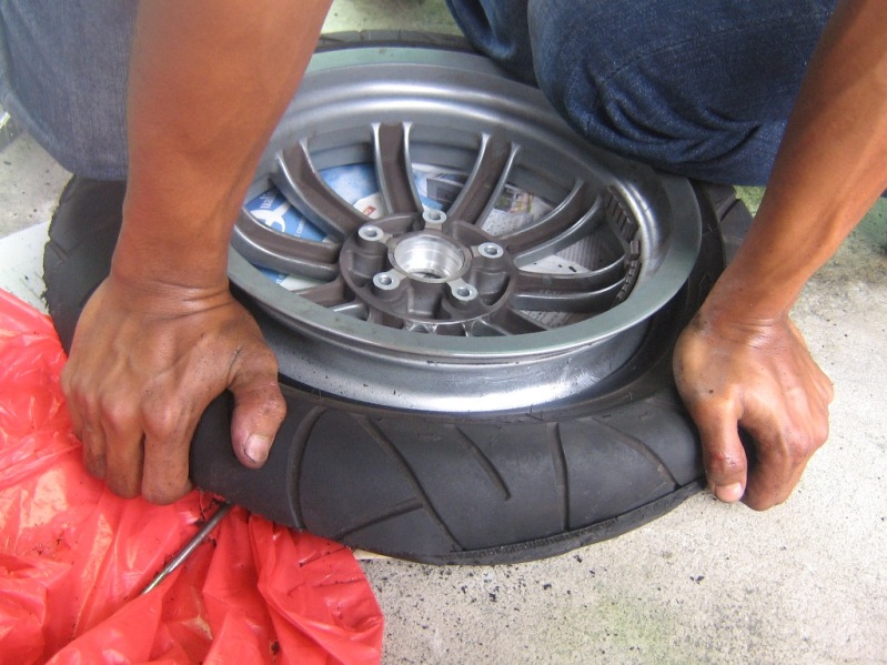 Modern Vespa Stone Age tire change.