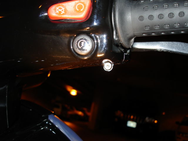 Remove retaining screw beneath ignition button and likewise on the opposite end below horn button.