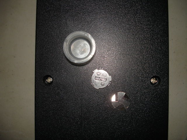 The cup, the plastic locking washer, spring loaded washer.
