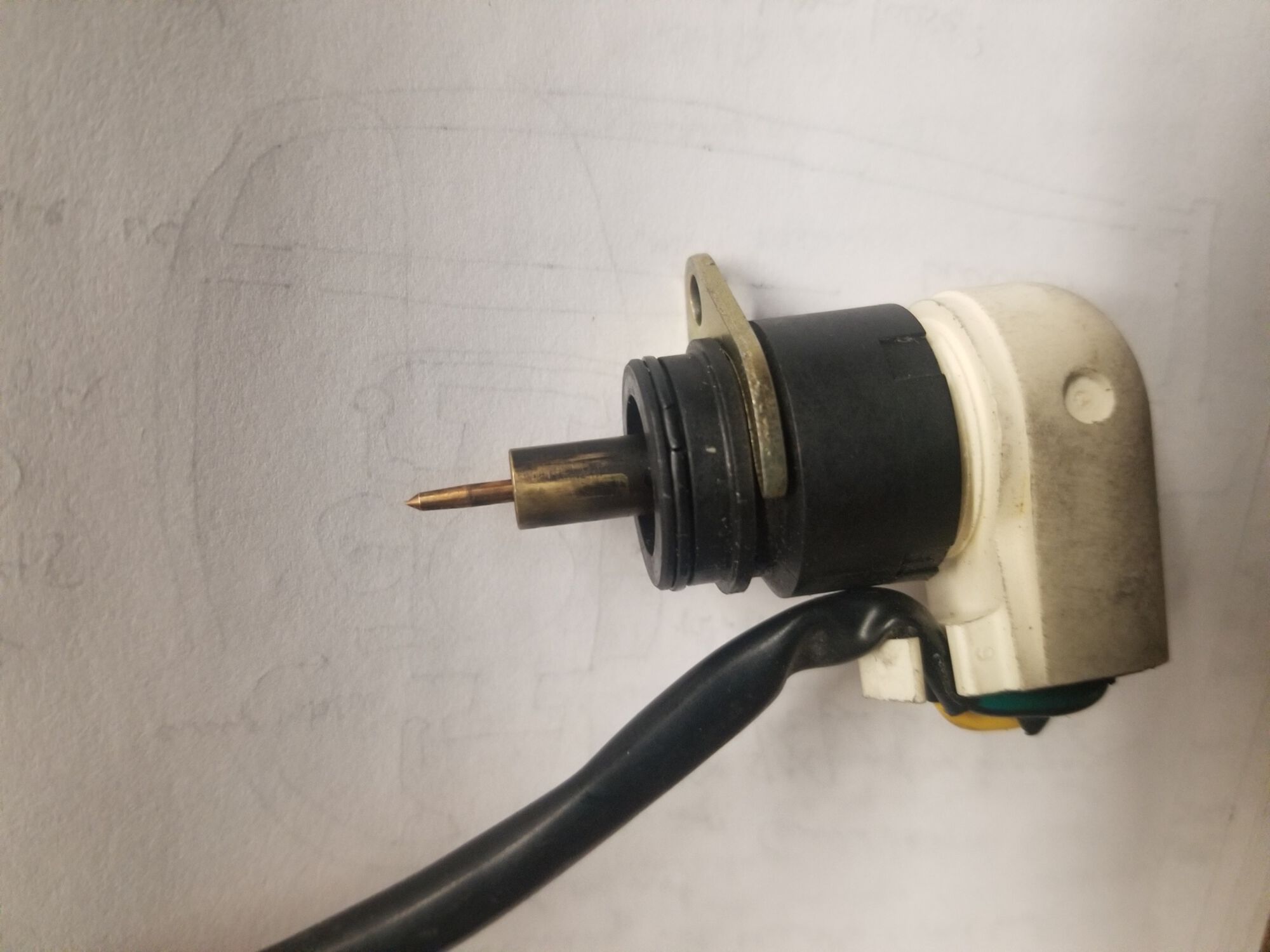 Choke assembly. There was black crud on the brass cylinder. I cleaned that later, and it ran better, but still needed throttle blips to avoid stalling every few seconds.