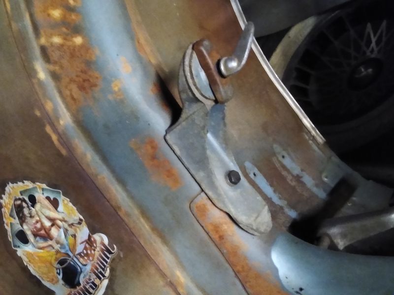 This old spare bracket was made for 8" wheels. It holds the wheel w/ tire fairly tight to frame.