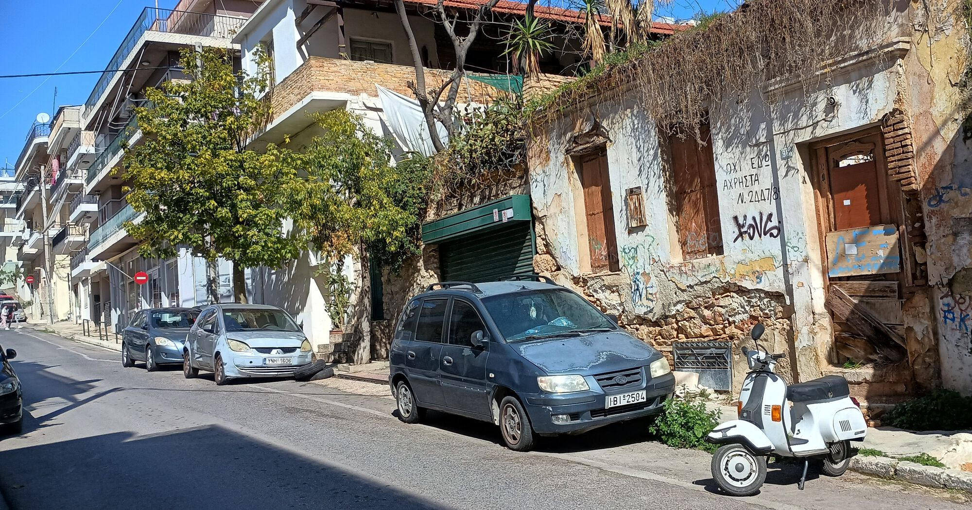 An old long abandoned  house that will likely be demolished for a new apartment building. These places  are often 'owned' by the children of the residents who have passed away, and they have left Greece for greener pastures