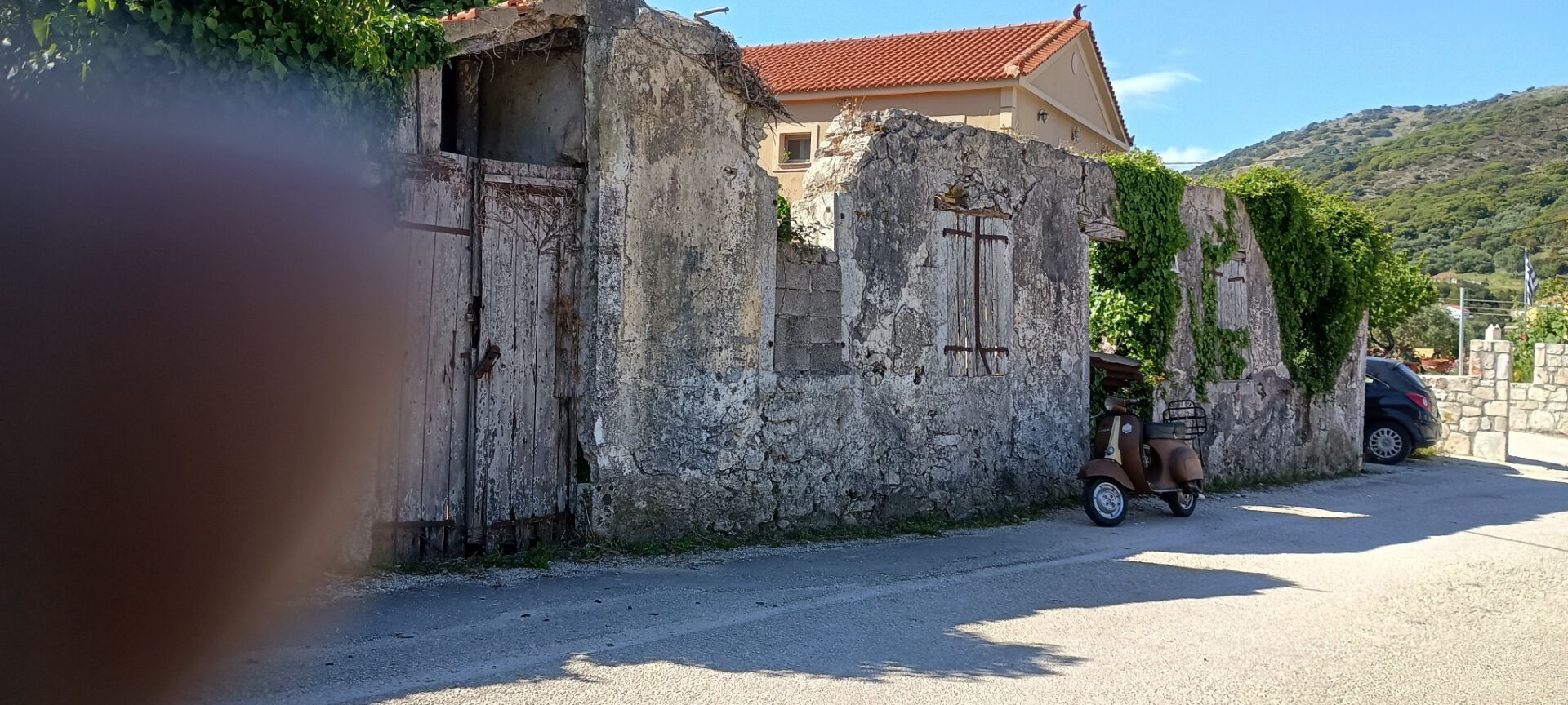 Next down the road are what's left of the outbuildings (and a fuzzy view of my fingertip?)