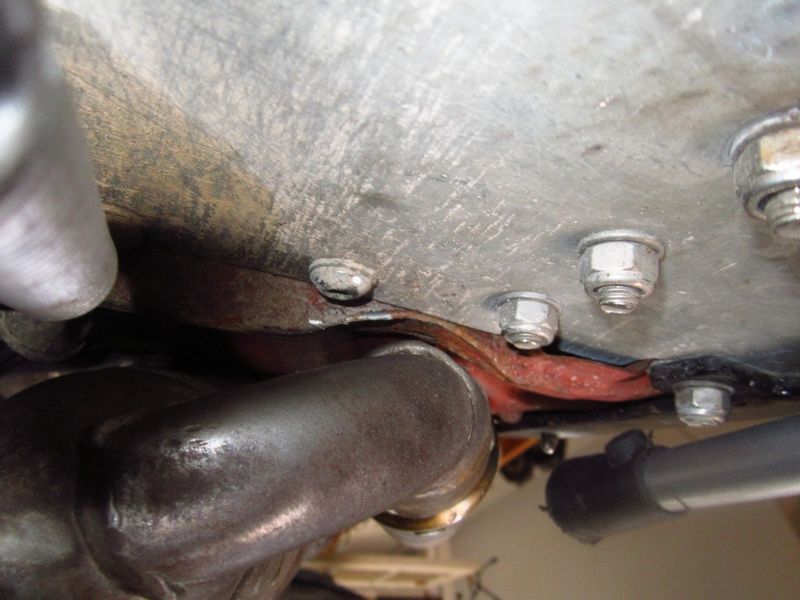 modified muffler mounting so I can change the bigger tire w/o removing 
big ball peen hammer at work on that last remaining reinforcing rib