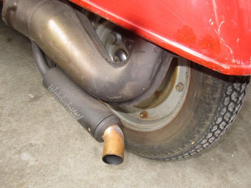 The black doughnut around it is hi temp rubber and had a smaller rubber 45 degree outlet that tore off
This elbow slips over the outlet pipe & is secured by a screw out of sight behind the doughnut.