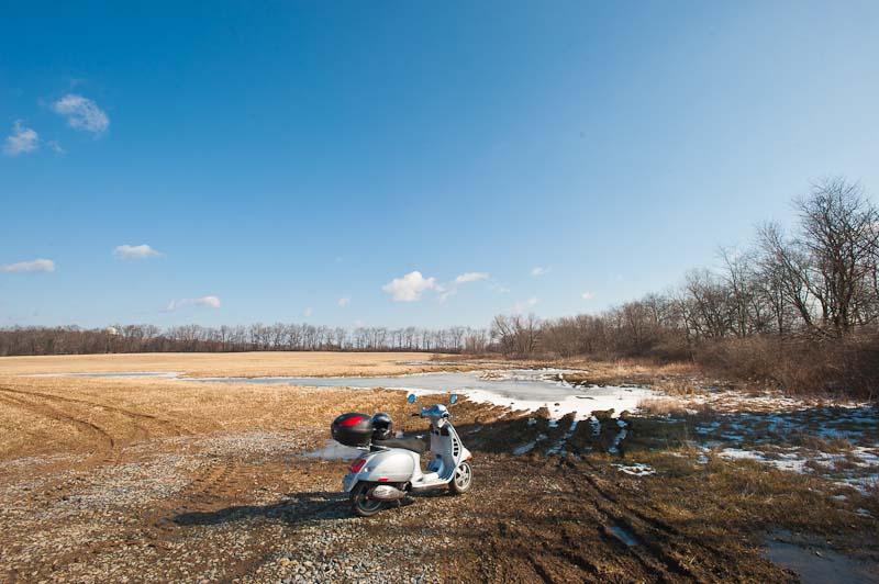 Vespa GTS 250ie along Circleville Road in a muddy field.