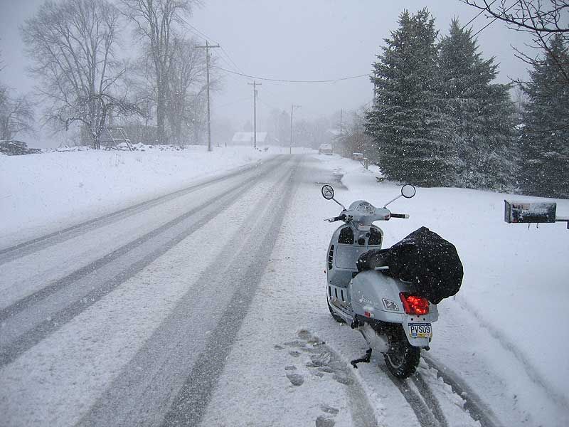 A long past ride home from work in unexpected snow.  I was younger then.  Now . I would have left the scooter at work and taken the bus home.