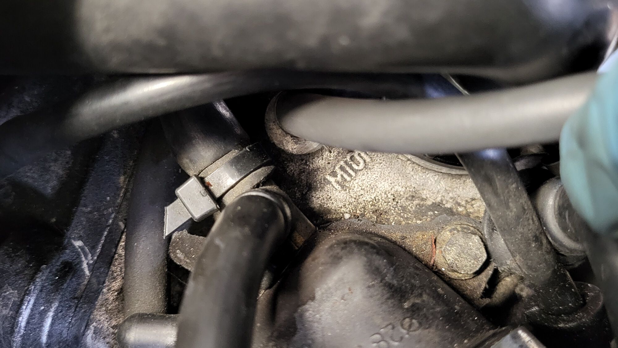 Between the thermo housing and the intake manifold