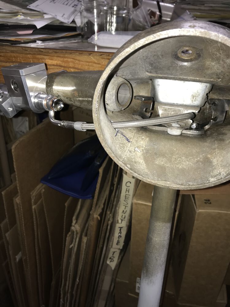 It's a tight fit, but my LED headlight will fit with that brake line located there.