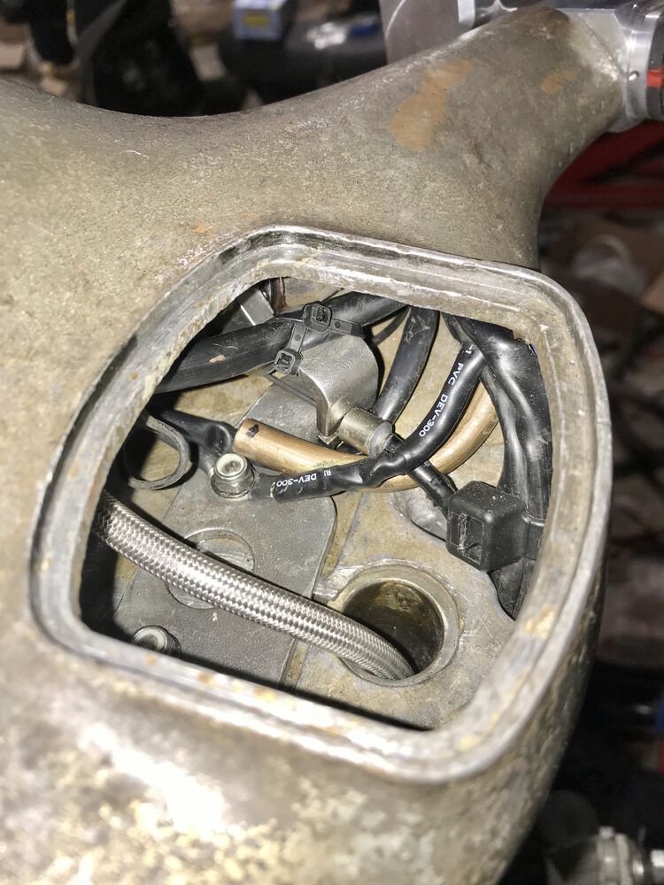 I jammed that 5/16" diameter tube under the throttle cable. It looks ghetto, but it works perfectly.