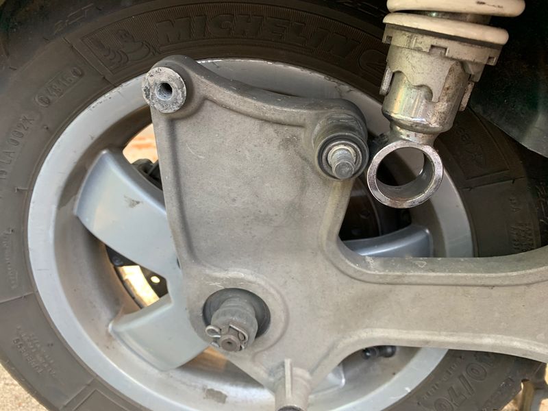 This is after I had removed the nut and washer.  You can see the bushing still on the shaft with the bottom of the shock detached.